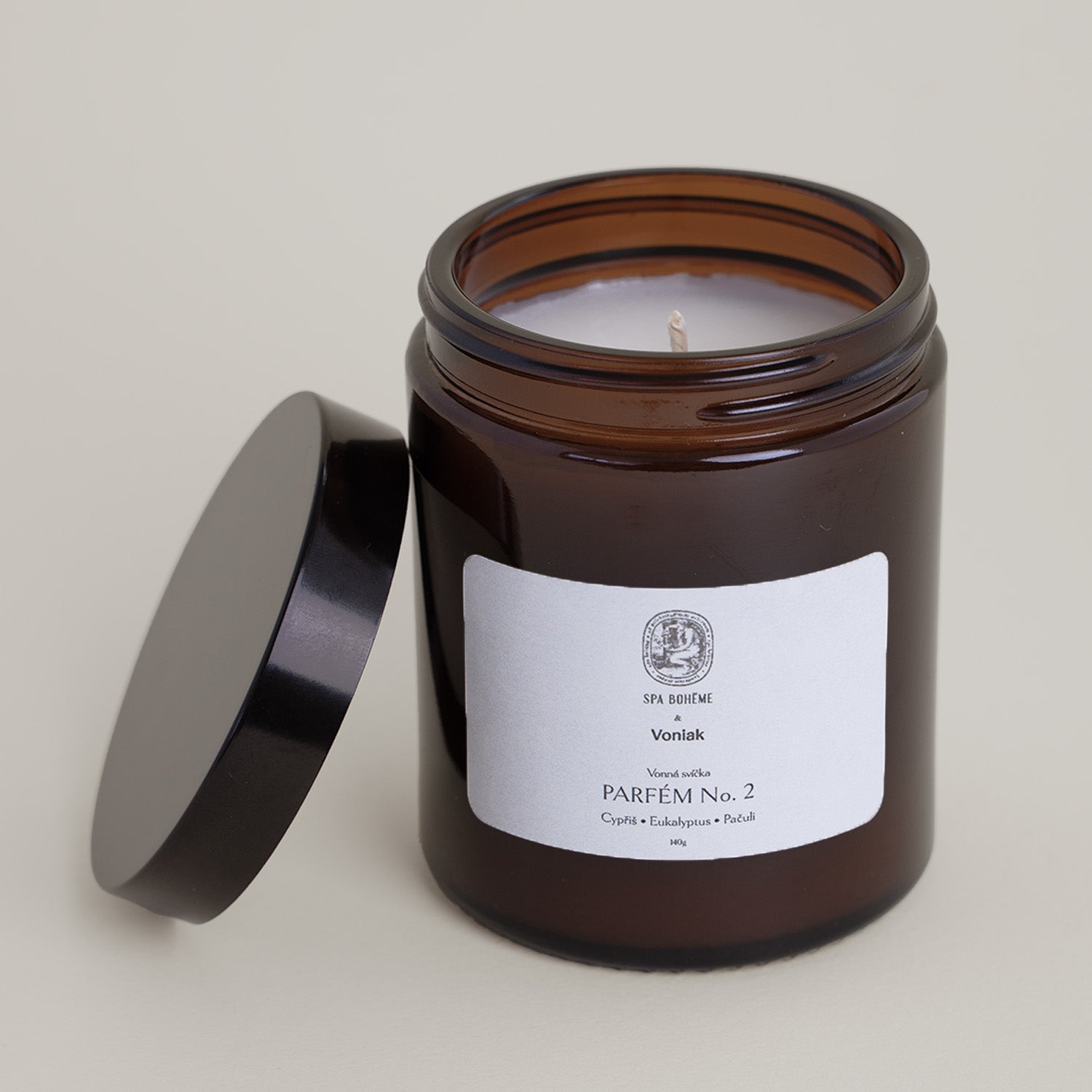Candle in a brown glass with with label